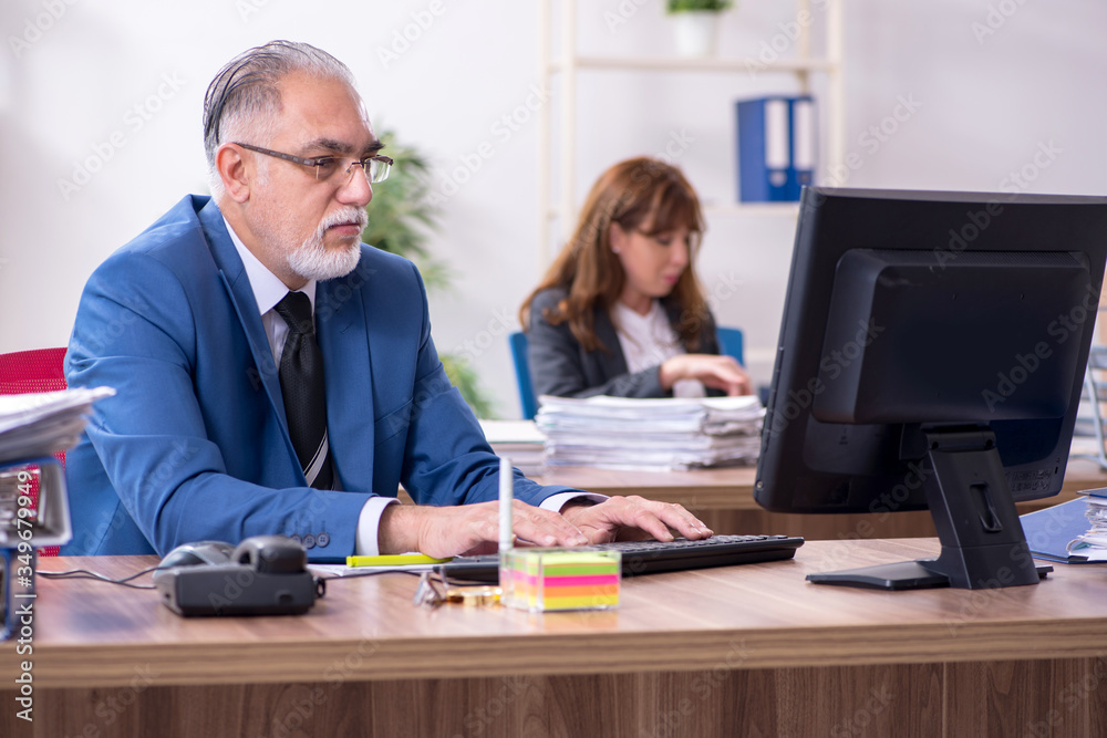 Two employees working in the office Two employees working in the office