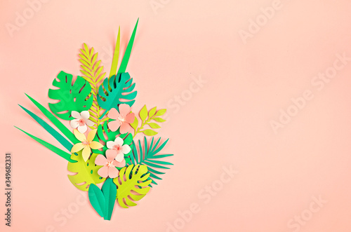 Paper tropical leaves and flowers over pink pastel background. Summer exotic vacation, greeting card mockup