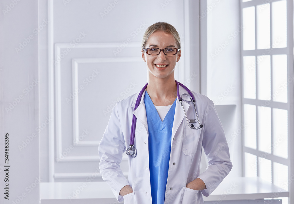 Portrait of a happy smiling young doctor in headset in office Portrait of a happy smiling young doctor in headset in office