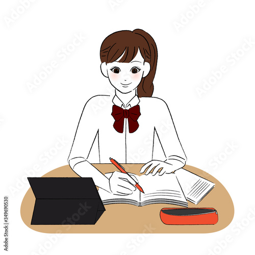 タブレットを見ながら勉強する女子学生