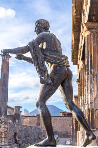 Pompeii in Italy, ruins of the antique Temple of Apollo with bronze Apollo statue, Naples.