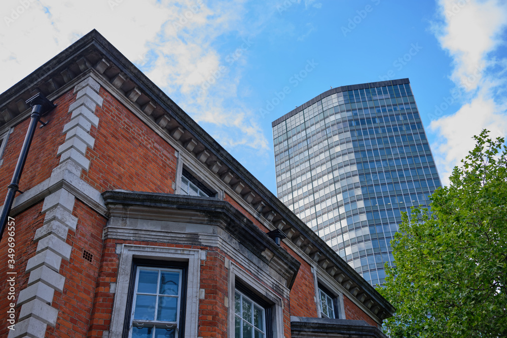 Looking up to modern Millbank Tower with older building in foreground Looking up to modern Millbank Tower with older building in foreground