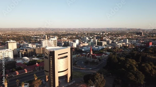 4K aerial drone summer sunset video of Windhoek national Independence Museum building in city center in Namibia's capital in central highland of Namibia, southern Africa