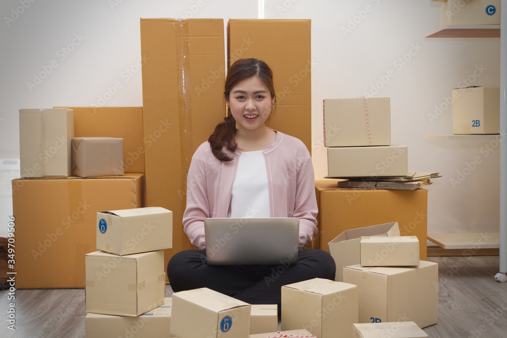 Smile and happiness of asian Women business owner working at home with packing box on workplace and ready to deliver the product. Online shopping SME entrepreneur or online selling concept. Smile and happiness of asian Women business owner working at home with packing box on workplace and ready to deliver the product. Online shopping SME entrepreneur or online selling concept.
