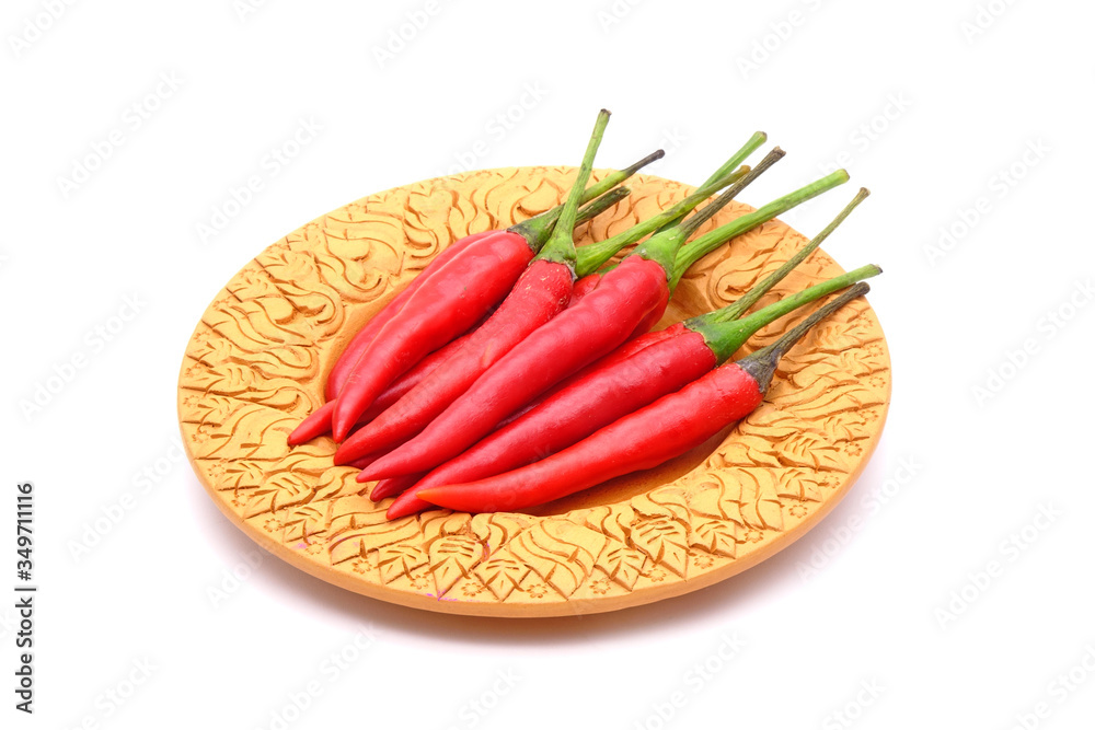 Red hot chili peppers on Thai style clay dish isolated on white background. Selective focus
