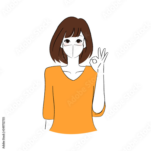 マスクをして指で丸をつくる女性