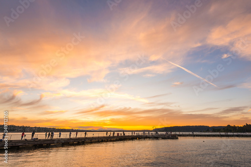 scene of walk way on the lake when sunset.