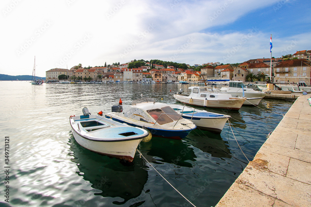 Row boats moored at the waterfront of the town of Milna in the island of Brac in Croatia - Small fishing village in the Adriatic Sea
