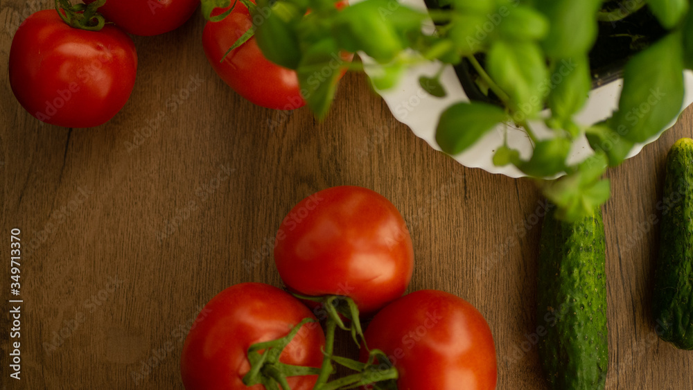 
Vegetables. Tomatoes and cucumbers with basil. Ready free entry space