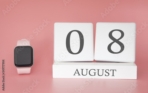 Modern Watch with cube calendar and date 08 august on pink background. Concept summer time vacation. photo