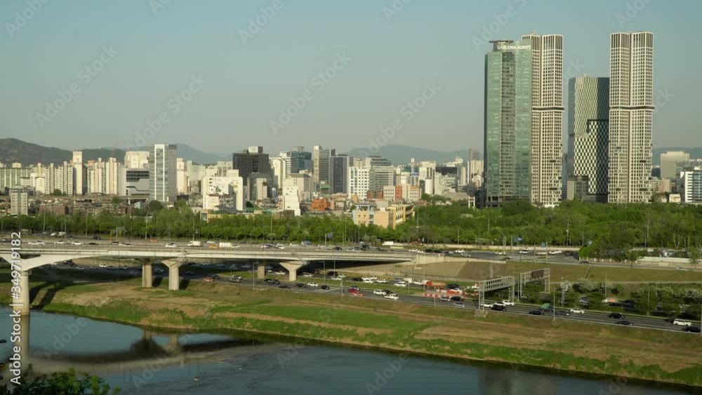 Car traffic at Eungbonggyo Bridge and Seoul freeway and Hanwha Galleria Pore, Acro Seoul Forest skyscrapers from High point of view Car traffic at Eungbonggyo Bridge and Seoul freeway and Hanwha Galleria Pore, Acro Seoul Forest skyscrapers from High point of view