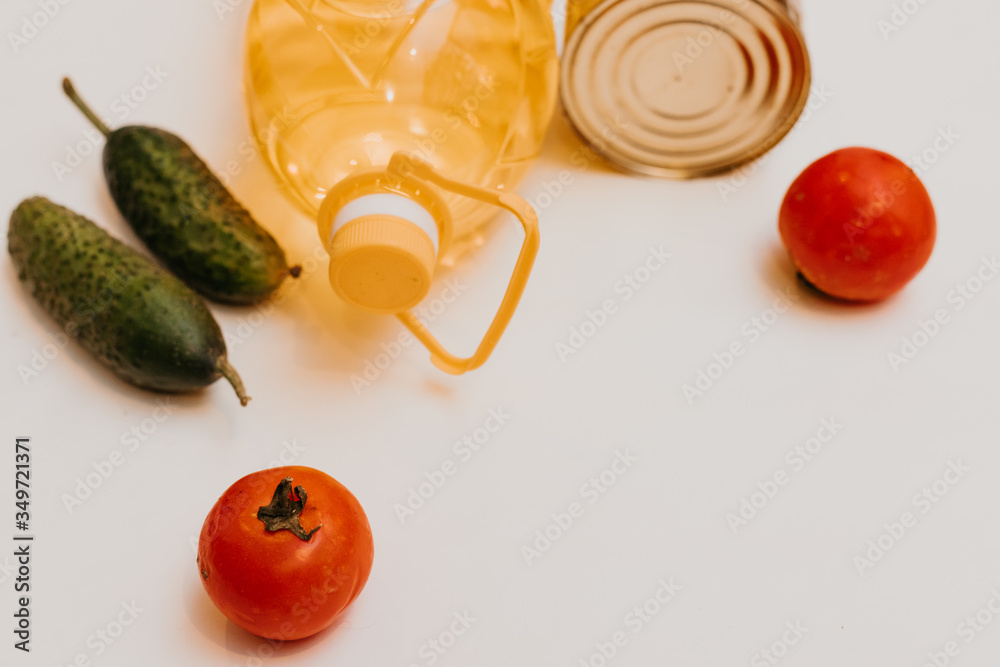 cucumbers, tomatoes, vegetable oil, eggs and canned goods isolated on white background.Food supplies crisis food stock for quarantine.Food delivery, Donation, coronavirus.Tape measure. - obrazy, fototapety, plakaty 