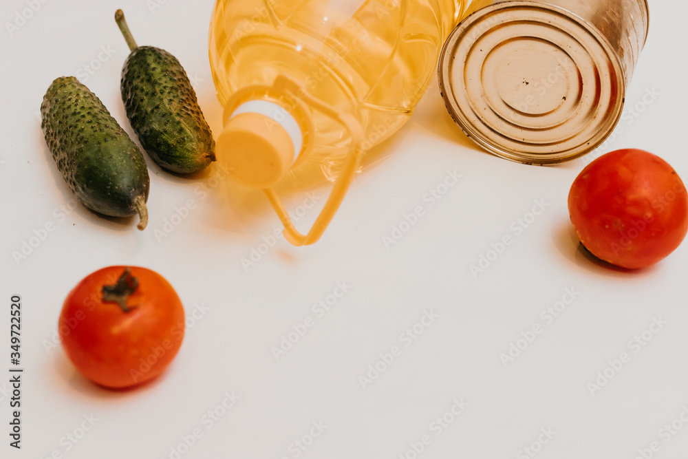 cucumbers, tomatoes, vegetable oil, eggs and canned goods isolated on white background.Food supplies crisis food stock for quarantine.Food delivery, Donation, coronavirus.Tape measure. - obrazy, fototapety, plakaty 