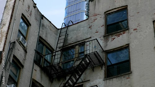 City fire escape on white building that leads to rooftop.