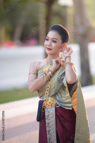 Thai women wear beautiful Thai dresses to come merit at temples. Culture concepts.