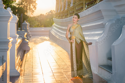 Thai women wear beautiful Thai dresses to come merit at temples. Culture concepts.