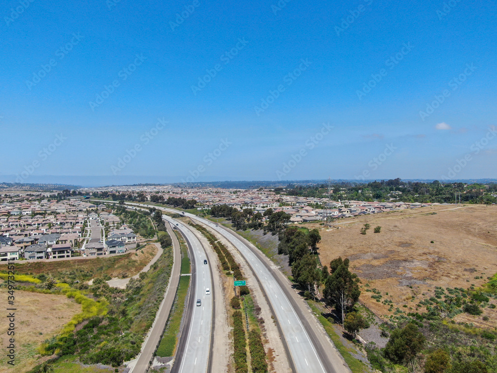 Aerial view of highway, freeway road with vehicle in movement with blue sky baclground, California, USA.