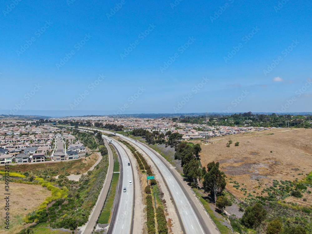 Aerial view of highway, freeway road with vehicle in movement with blue sky baclground, California, USA. Aerial view of highway, freeway road with vehicle in movement with blue sky baclground, California, USA.