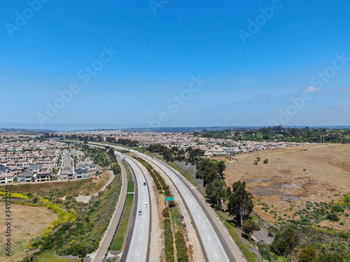 Aerial view of highway, freeway road with vehicle in movement with blue sky baclground, California, USA.