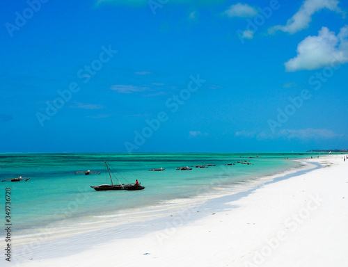 Fishing boats and crystal clear turquoise waters at paje beach village on the island of zanzibar.