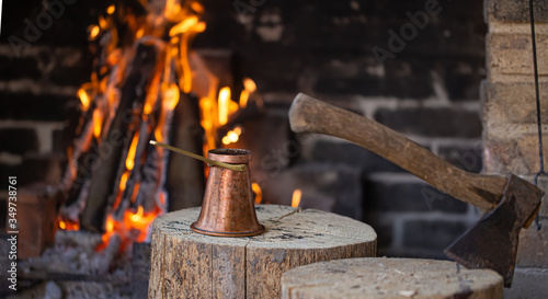 Brewing coffee in a Turk on an open fire .