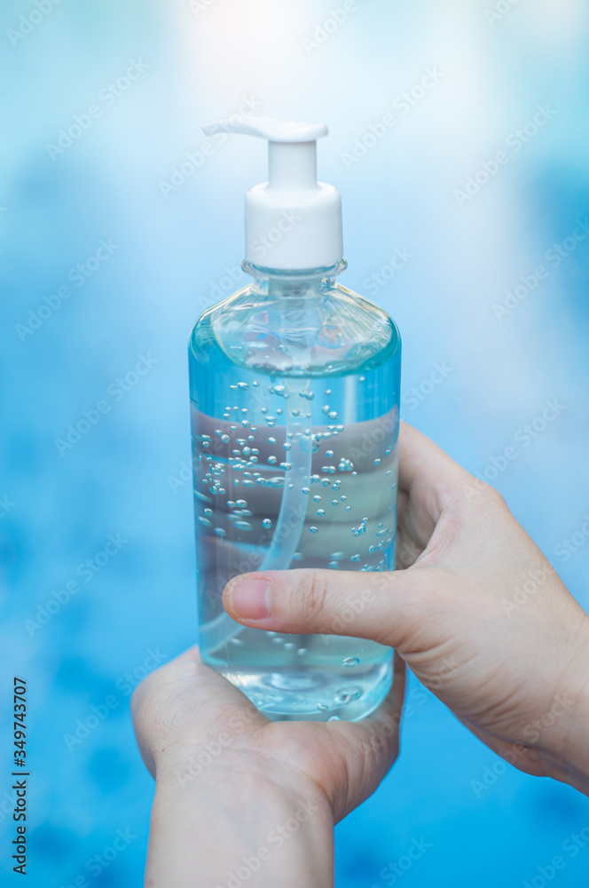 Businesswoman washing his hands with an alcohol gel in a pump-like bottle to prevent the spread of the Covid-19 virus. Businesswoman washing his hands with an alcohol gel in a pump-like bottle to prevent the spread of the Covid-19 virus.