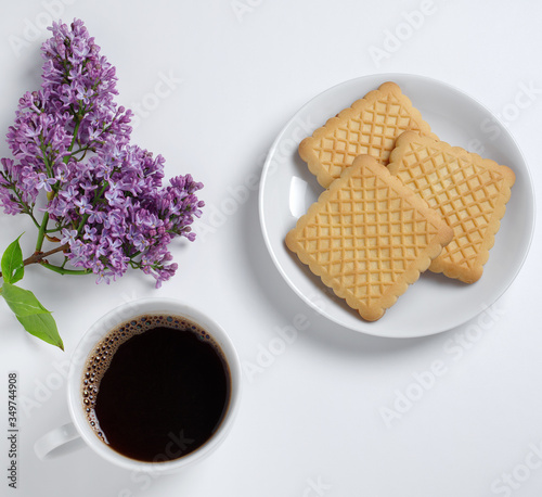 Coffee, cookies and lilac flowers