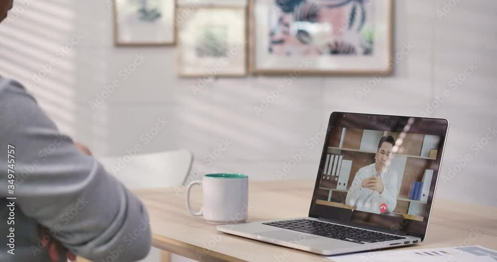 Young asian business man speaking looking at laptop computer communicating by video call at home. online conference distance office chat, working at home in quarantine of global coronavirus epidemic. Young asian business man speaking looking at laptop computer communicating by video call at home. online conference distance office chat, working at home in quarantine of global coronavirus epidemic.