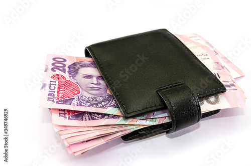 a lot of hryvnia in a men's wallet on a white background.