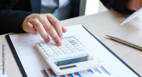 Accounting businessmen are calculating income-expenditure and analyzing real estate investment data, Dedicated to the progress and growth of the company, Financial and tax systems concept.