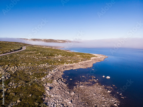 Road crossing Hardangervidda plateau, Norway. Aerial view. photo