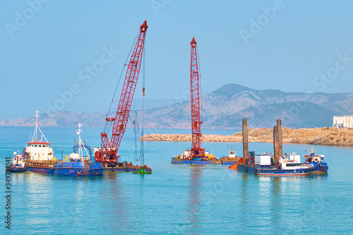 dredger floating platforms and other vessels on sea dredging works photo
