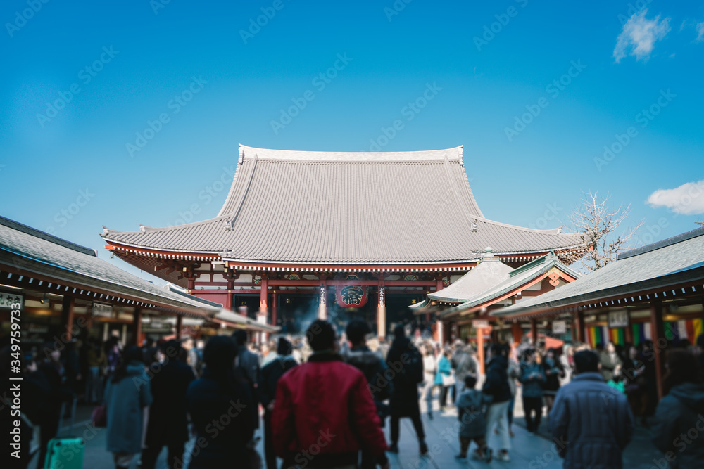 Fototapeta premium Blurry image Tourists pour in to pray at Sensoji or Asakusa Temple is temple Tokyo's largest Buddhist in the Asakusa area. People like to walk and pay a visit to both the temple and the outside.