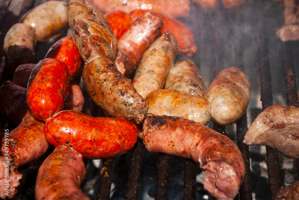 Grilled chorizo ​​sausages outdoors, celebrating plenty of protein meat and nutrition.