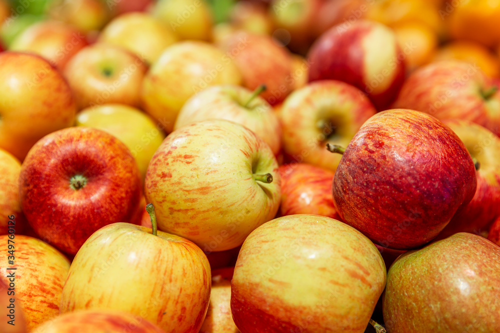 Fresh red-yellow apples on a counter in a supermarket. Healthy eating and vegetarianism. Close-up. Fresh red-yellow apples on a counter in a supermarket. Healthy eating and vegetarianism. Close-up.