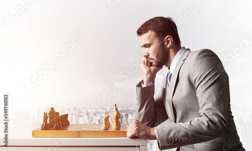 Businessman moving chess figure in chessboard