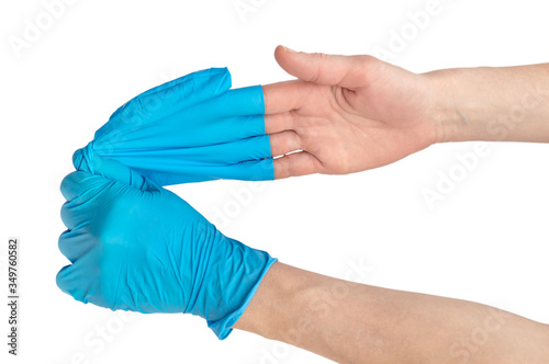 Nurse removing gloves from her hand. Close up. Isolated on white.