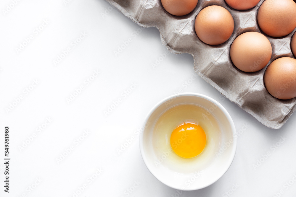 closeup of fresh chicken egg on egg box, panel, on white background with one fragile egg shell for cook for food of meal and fresh and natural egg in bowl closeup of fresh chicken egg on egg box, panel, on white background with one fragile egg shell for cook for food of meal and fresh and natural egg in bowl