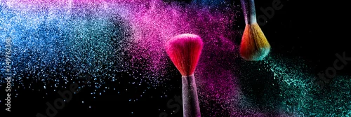 Obraz Two brushes with pink and blue make up powder impact to make a colorful cloud.