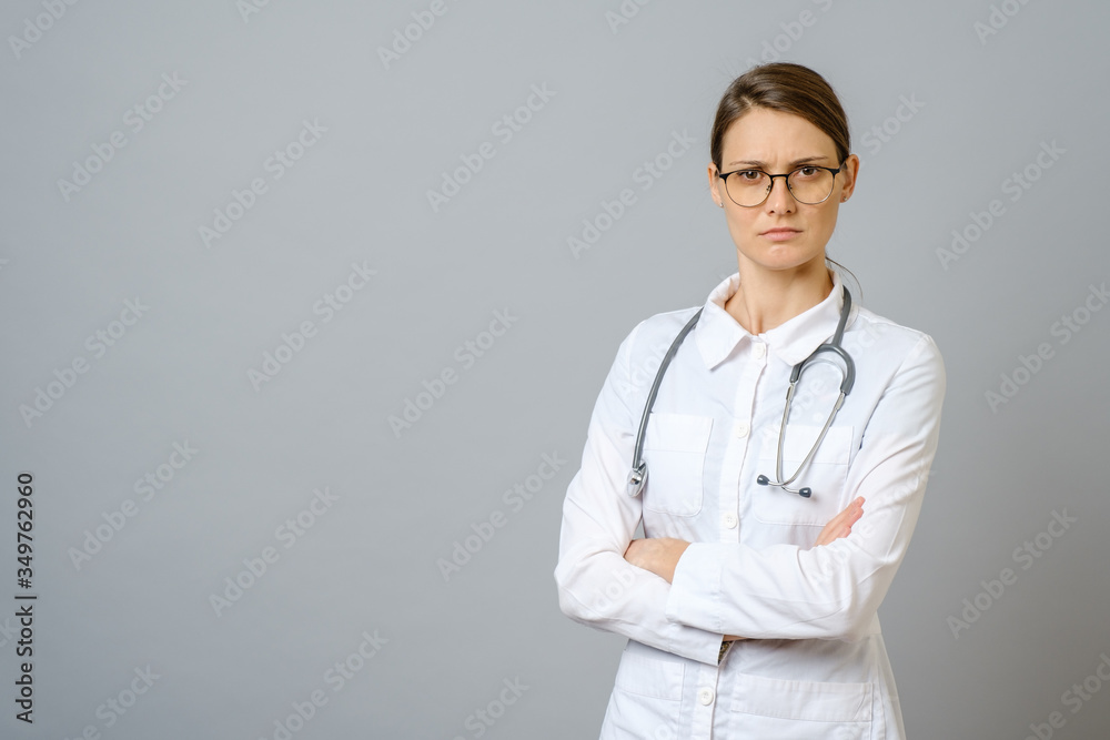 Portrait of serious doctor with stethoscope looking at camera Portrait of serious doctor with stethoscope looking at camera
