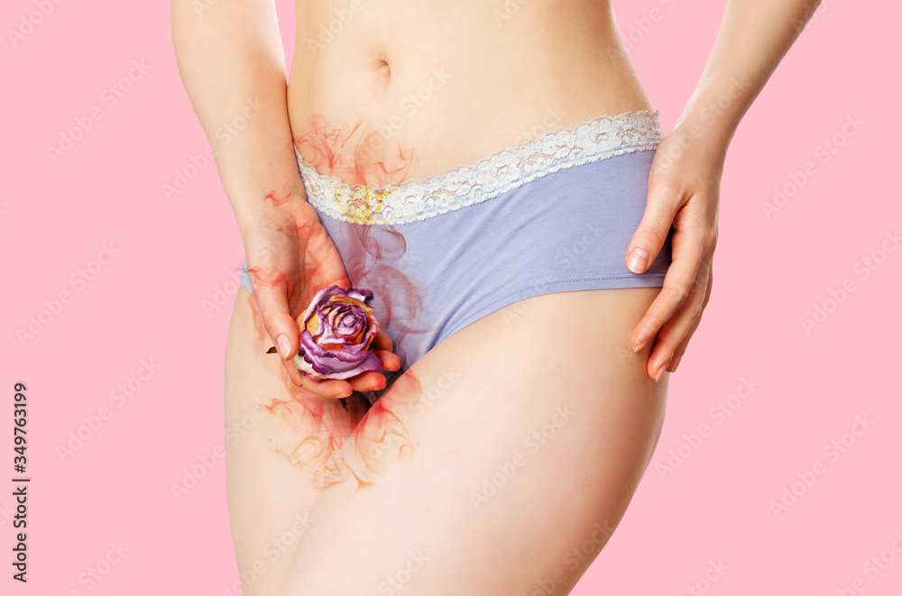 A woman in underwear holds a faded rose flower that exudes a black smell in  her