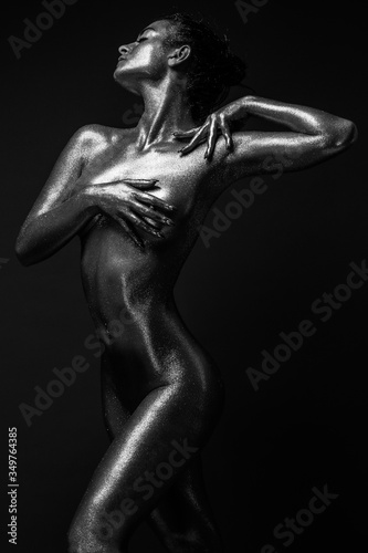 fashion sexy girl gold-plated glittering posing (black and white photo)