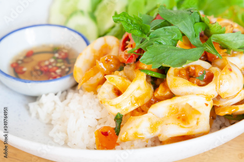 Closeup of stir fried squid with salted egg yolk served with steamed rice. Thai food.