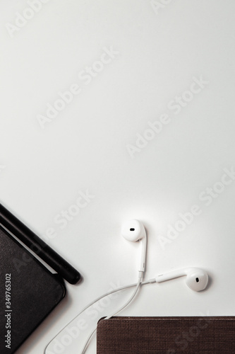 The layout of the verses on a white background. Business items with a book and headphones.