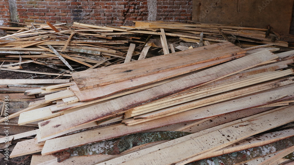 Lots of long wooden natural planed boards and sticks at a sawmill.