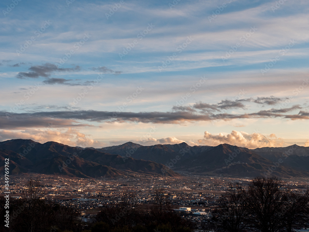 Kofu city in the evening surrounded by mountains