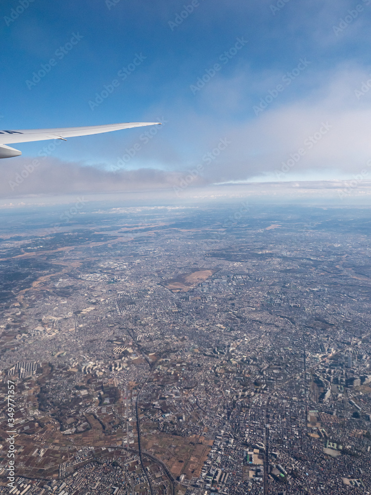 A distant city seen from an aeroplanes window.