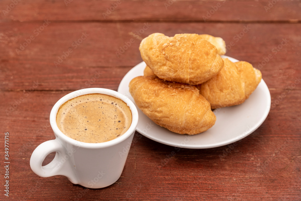 Croissants and espresso on wooden table Croissants and espresso on wooden table