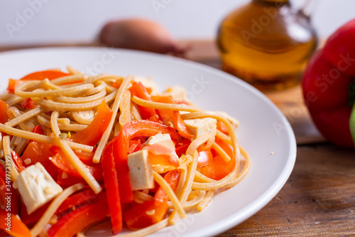 Vegan food  pasta with tofu and red peppers