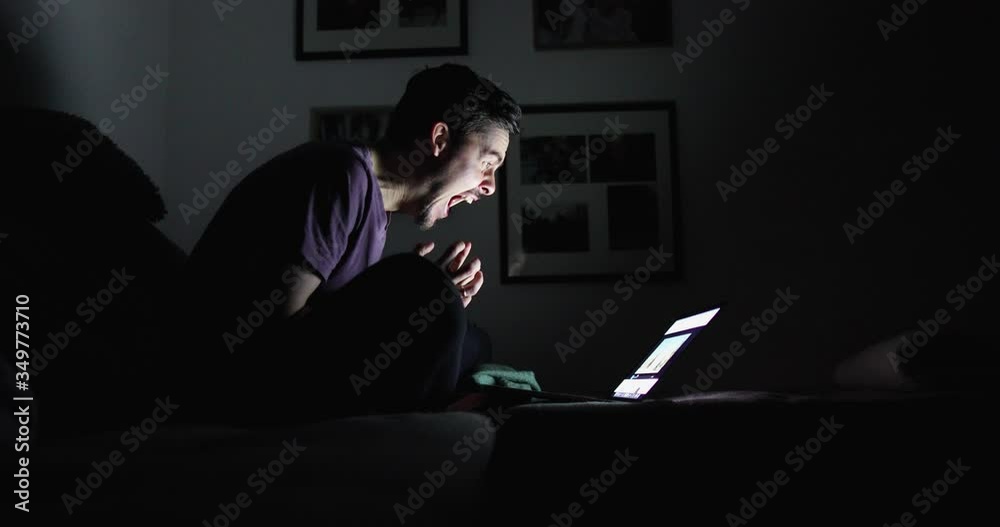 Bright emotions of a brunette with a beard from seen on the screen of a laptop Bright emotions of a brunette with a beard from seen on the screen of a laptop